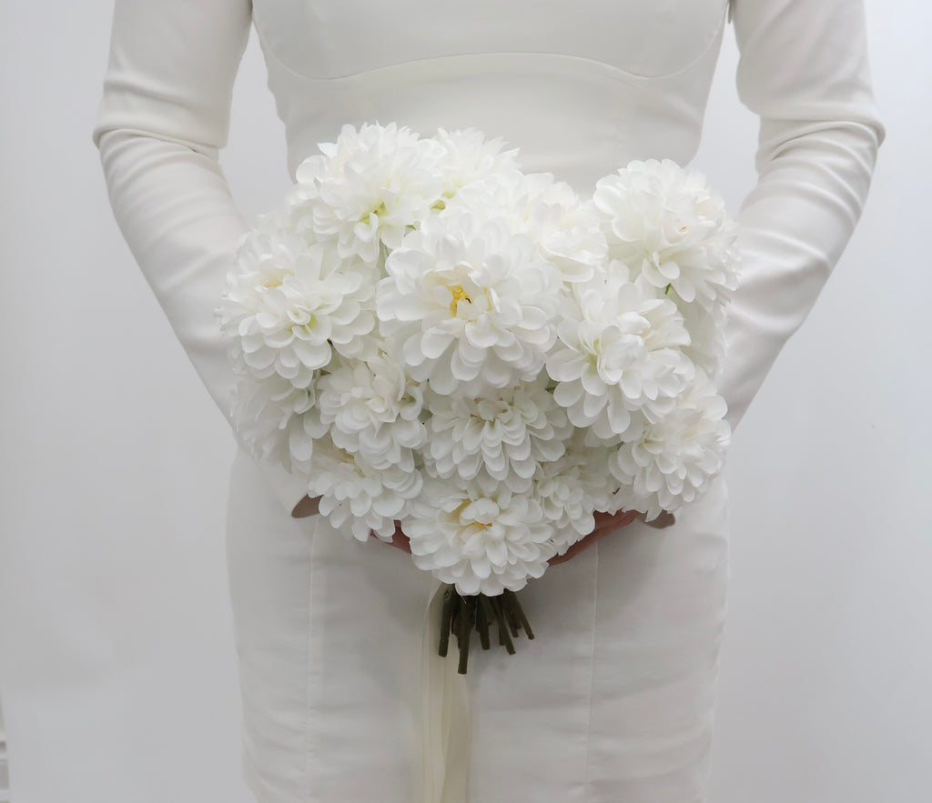 Bouquet of white dahlia flowers with a ribbon on a white background