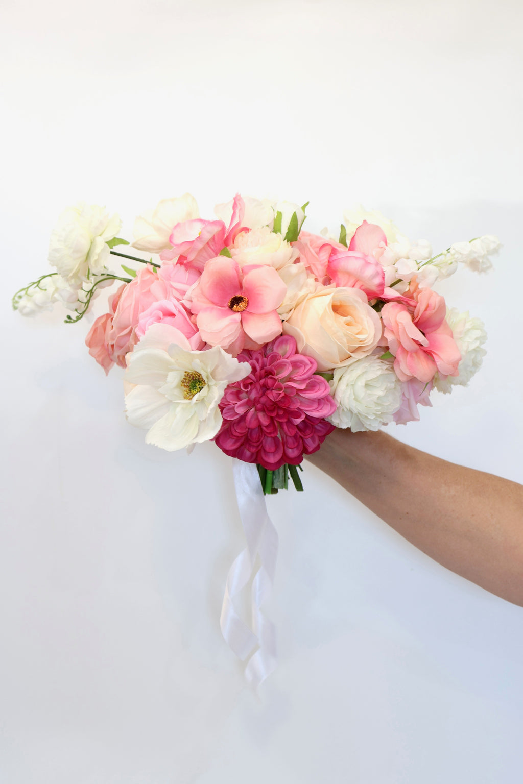 Whimsical wildflower bridal bouquet with pink, peach and white flowers